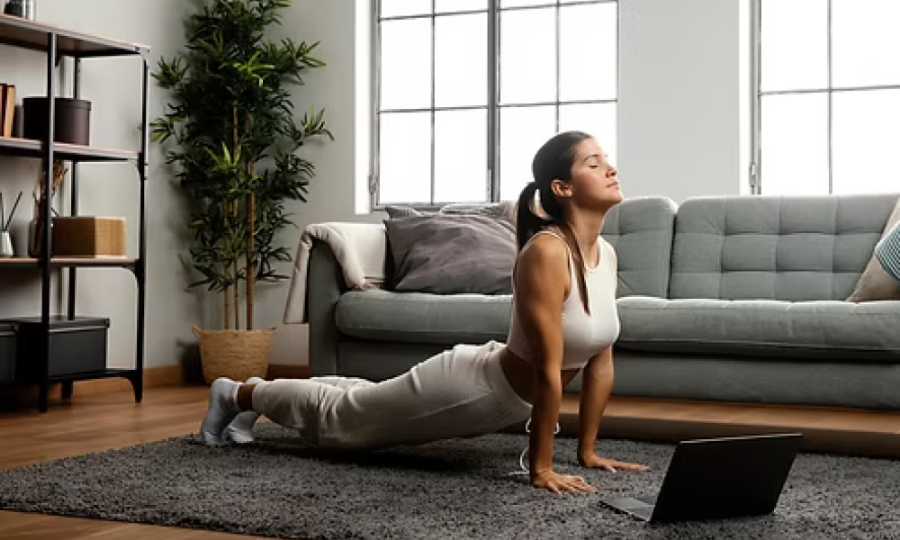 <span class="uk-h4">Woman stretching on a living room floor in front of a sofa and bookshelf</span>